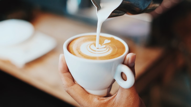 Artisanal latte art in ceramic cup at 1919 Grand Cafe